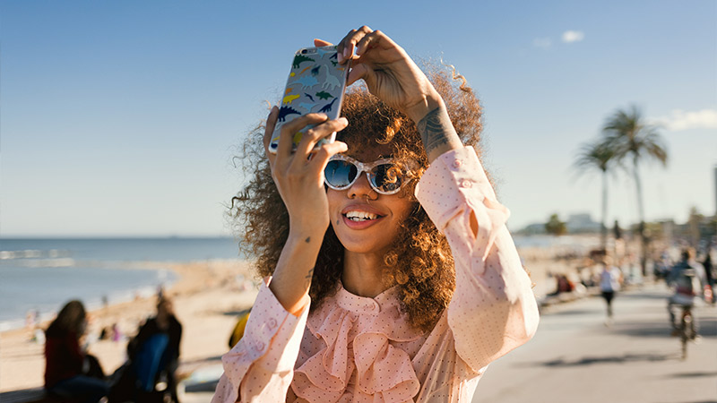 woman taking picture on beach